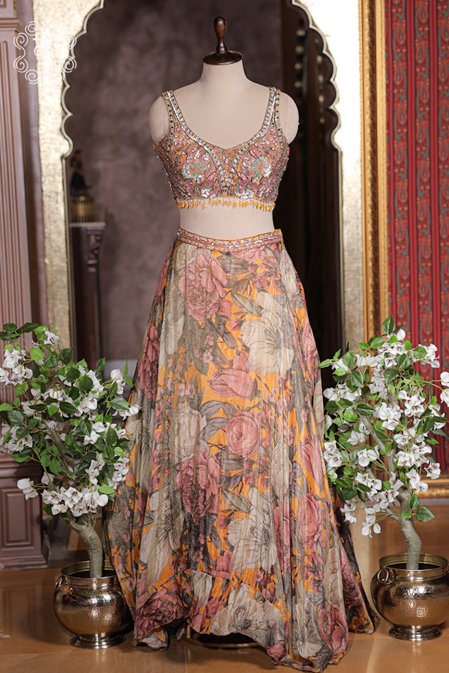 Detailed print texture of mustard yellow silk lehenga skirt with rose botanical print and embroidered waistband.