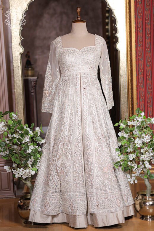 Close up of ivory white sweetheart neckline bodice with dense sequin and mirror embroidery.