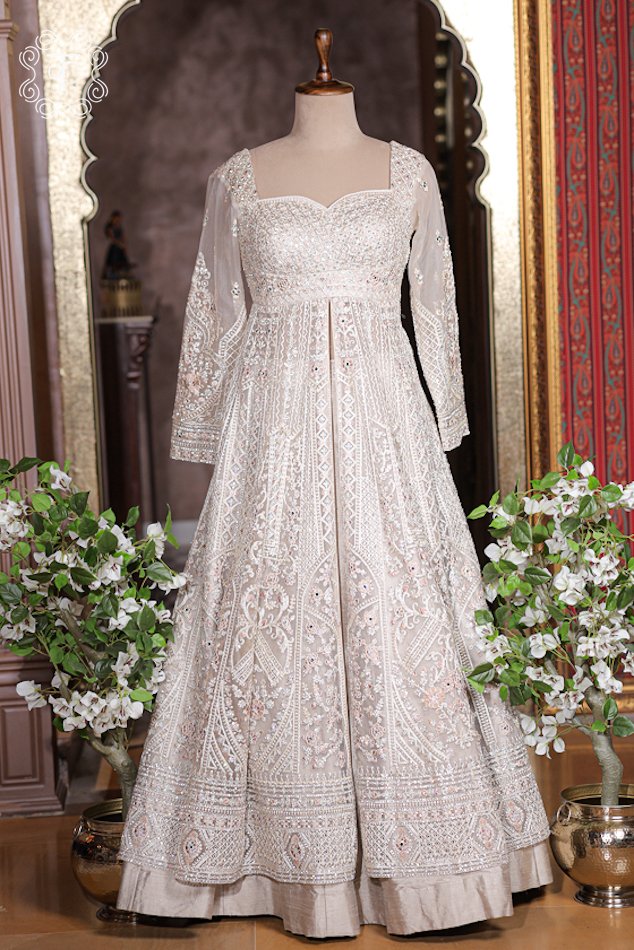 Close up of ivory white sweetheart neckline bodice with dense sequin and mirror embroidery.