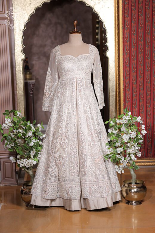 Sheer long sleeve of ivory jacket with detailed sequin threadwork and embroidered cuffs.