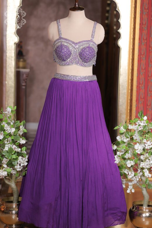 Close up of royal purple sleeveless sweetheart bustier with silver lattice mirror work and sequins.