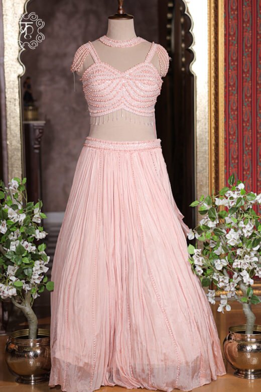 Scalloped hem of pearl corset top featuring hanging glass bead tassel fringes.