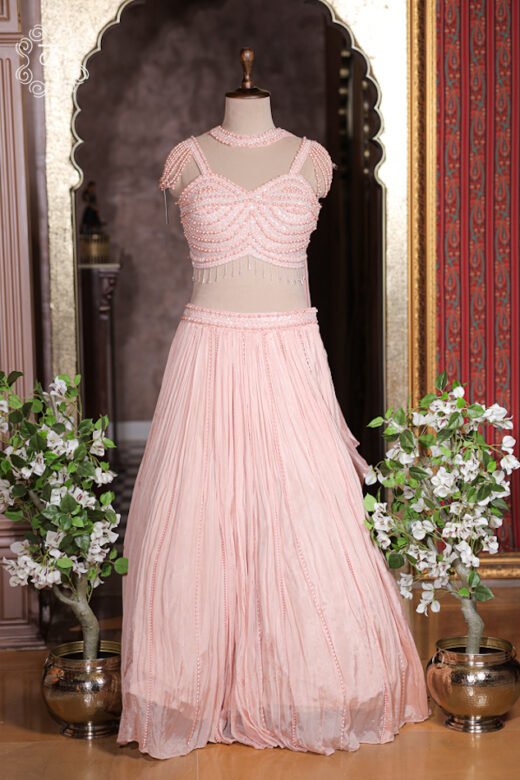Micro crush georgette fabric texture of blush pink lehenga skirt with vertical pearl beaded lines.