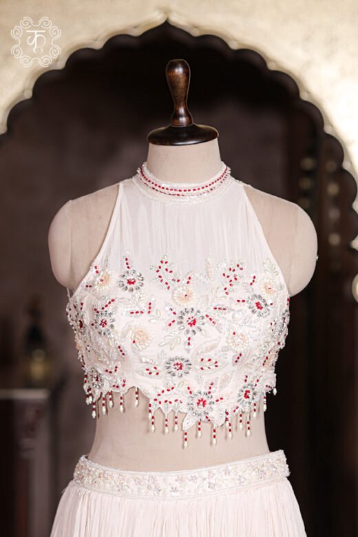 Micro crush pleat fabric detail of blush pink georgette lehenga skirt with pearl embroidered waistband.