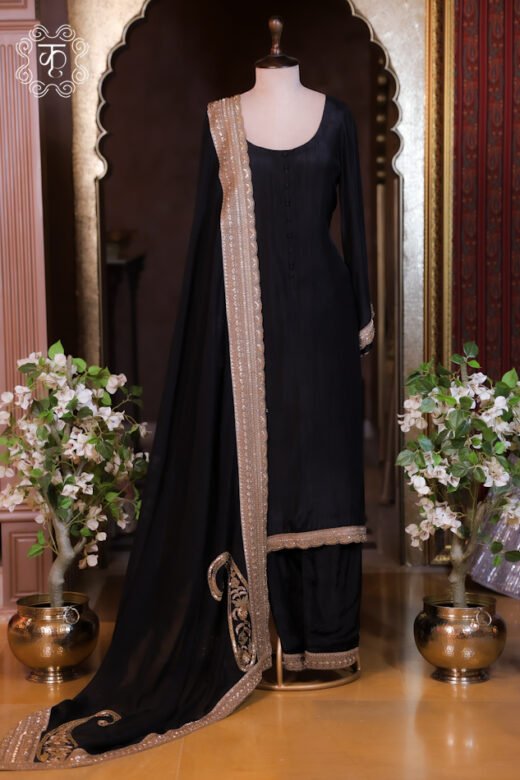 Black full-sleeve salwar suit set displayed on a mannequin with a gold zardozi embroidered organza dupatta in a palace set