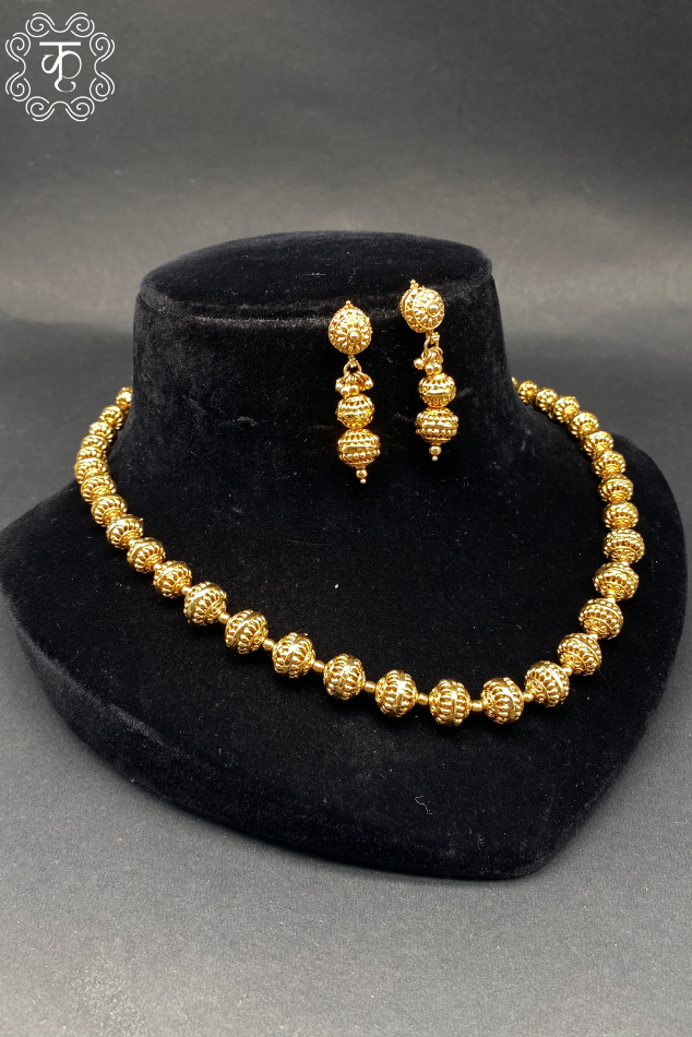 Gold beaded necklace and earrings set on velvet display — Kridhaa Temple Neckpiece collection