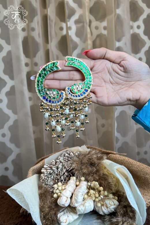 Gold and green stone pendant with dangling bead drops, held in hand — Kridhaa Kashmiri Jewellery collection