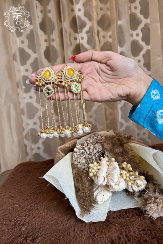 Long gold chain Kashmiri earrings with floral studs, held in hand — Kridhaa Kashmiri Earrings collection