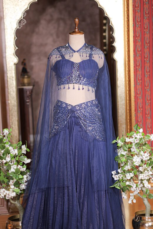 Close up of navy blue sweetheart bustier top with crystal fringes and high-collar sheer net cape.