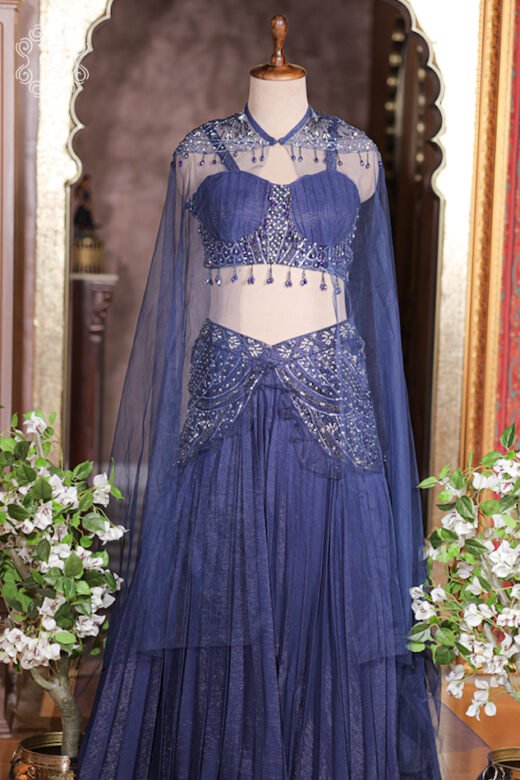 Floor length sheer net cape draped over shoulders with hanging bead tassels along shoulder collar.