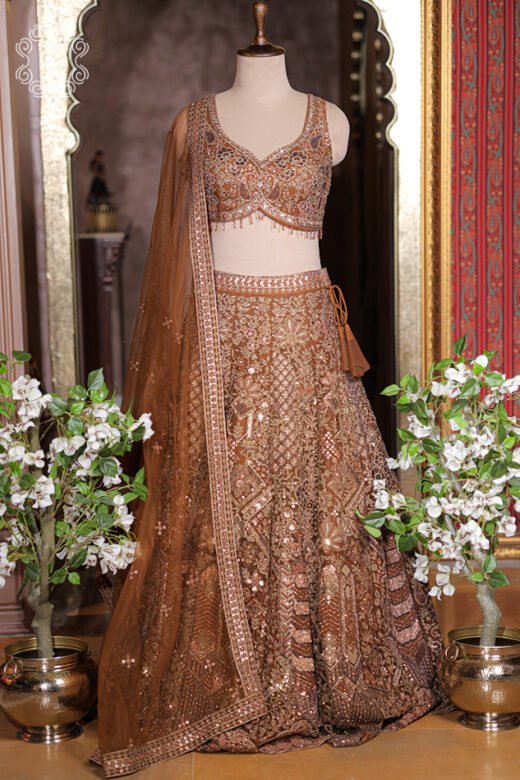 Rust bronze heavily embroidered net lehenga set with sweetheart choli and net dupatta.