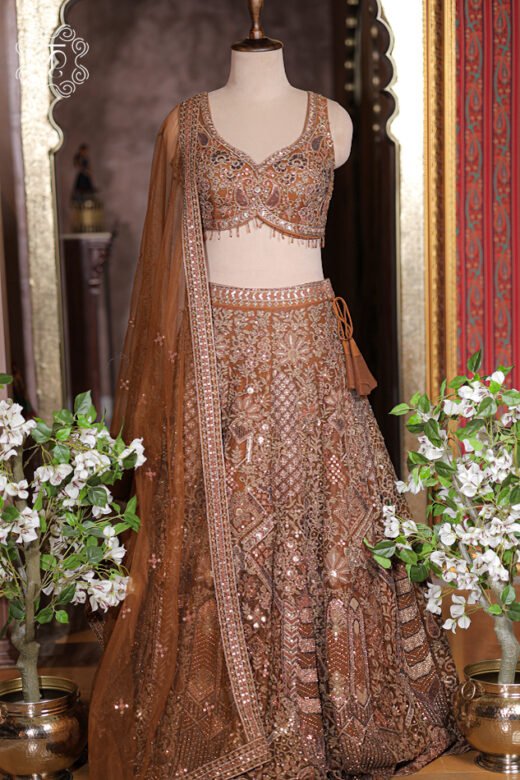 Sheer rust bronze net dupatta with sequin-embroidered border trim draped neatly over shoulder.