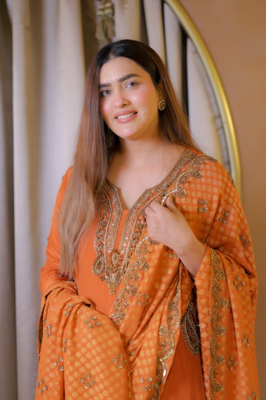 Orange festive embroidered suit set with detailed neckline and dupatta