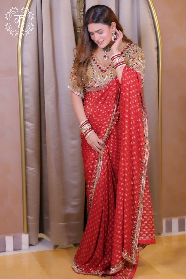 Red festive saree with embellished blouse and gold detailing