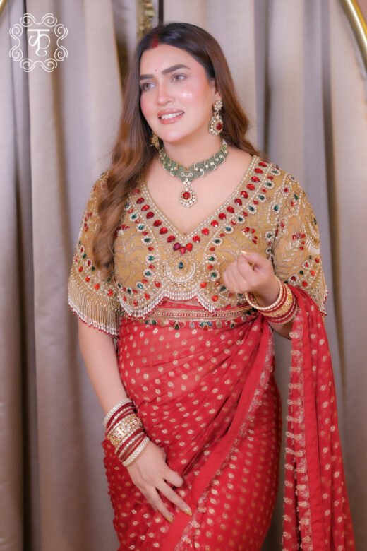Red designer saree with gold motifs and embellished blouse