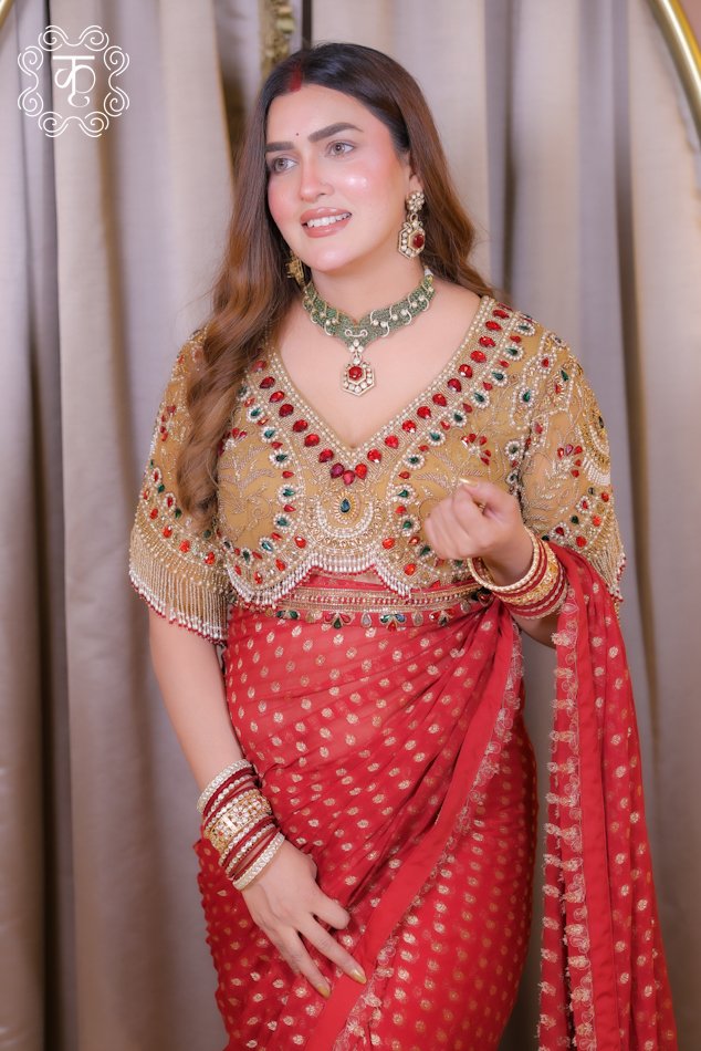 Red designer saree with gold motifs and embellished blouse