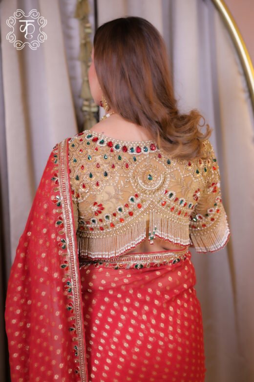 Red wedding designer saree with gold motifs and blouse