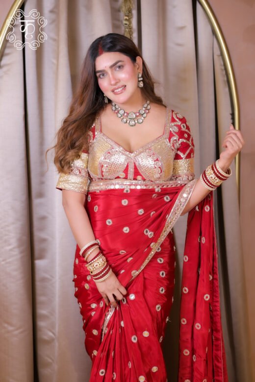Red luxury designer saree with gold embellishments and blouse