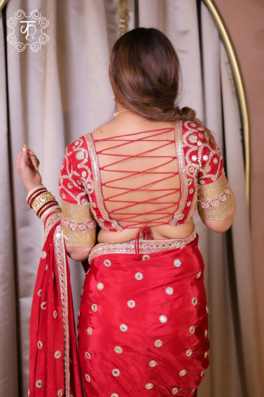Red wedding designer saree with gold motifs and embellished border