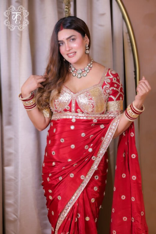 Red festive embroidered saree with gold motifs and blouse